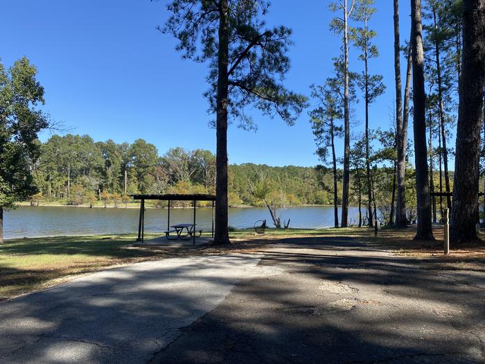 A photo of Site 009 of Loop E at MILL CREEK (TEXAS) with Picnic Table, Electricity Hookup, Fire Pit, Shade, Waterfront, Lantern Pole, Water Hookup