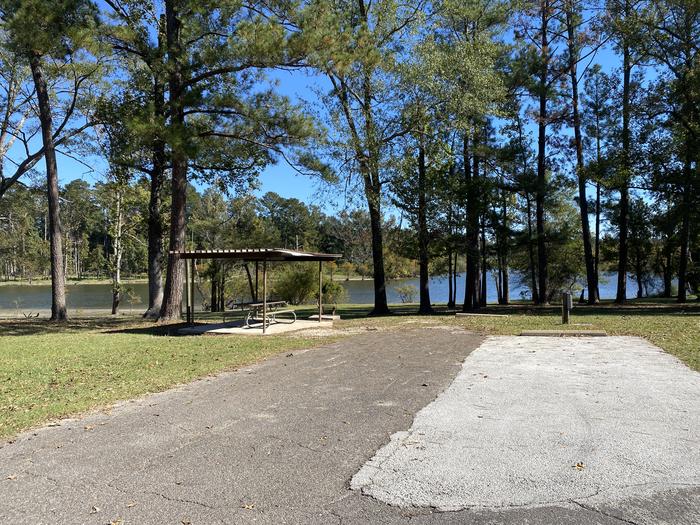 A photo of Site 018 of Loop E at MILL CREEK (TEXAS) with Picnic Table, Electricity Hookup, Fire Pit, Shade, Waterfront, Water Hookup