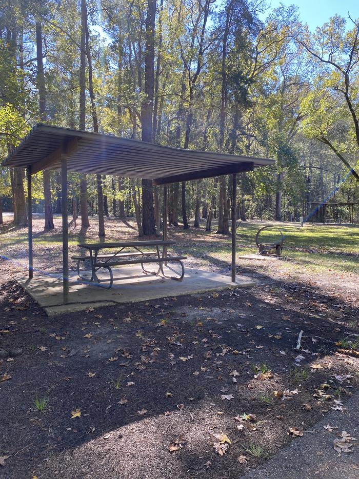 A photo of Site 003 of Loop E at MILL CREEK (TEXAS) with Picnic Table, Electricity Hookup, Fire Pit, Shade, Lantern Pole, Water Hookup, Lean To / Shelter