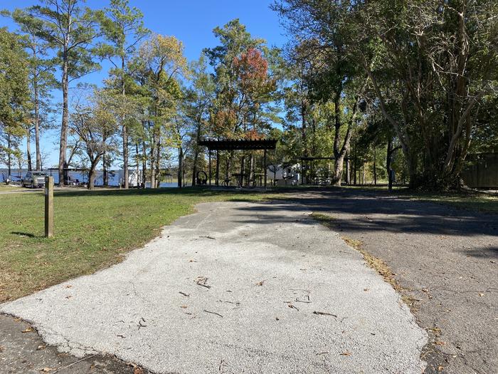 A photo of Site 027 of Loop E at MILL CREEK (TEXAS) with Picnic Table, Electricity Hookup, Fire Pit, Shade, Lantern Pole, Water Hookup