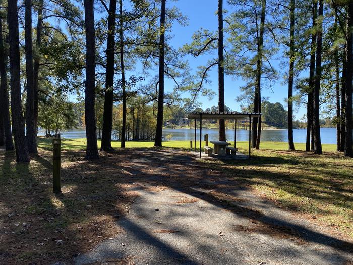 A photo of Site 096 of Loop D at MILL CREEK (TEXAS) with Picnic Table, Electricity Hookup, Fire Pit, Shade, Waterfront, Lantern Pole, Water Hookup
