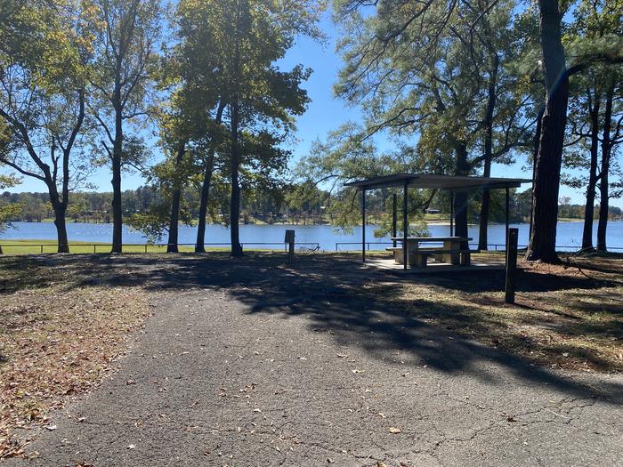 A photo of Site 089 of Loop D at MILL CREEK (TEXAS) with Picnic Table, Electricity Hookup, Fire Pit, Shade, Waterfront, Lantern Pole, Water Hookup