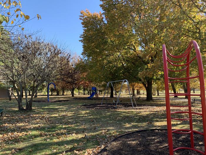Children's playground filled with a swing set, slide, and monkey bars located in the Brush Creek campground.A photo of facility Brush Creek Public Use Area with children playground.  