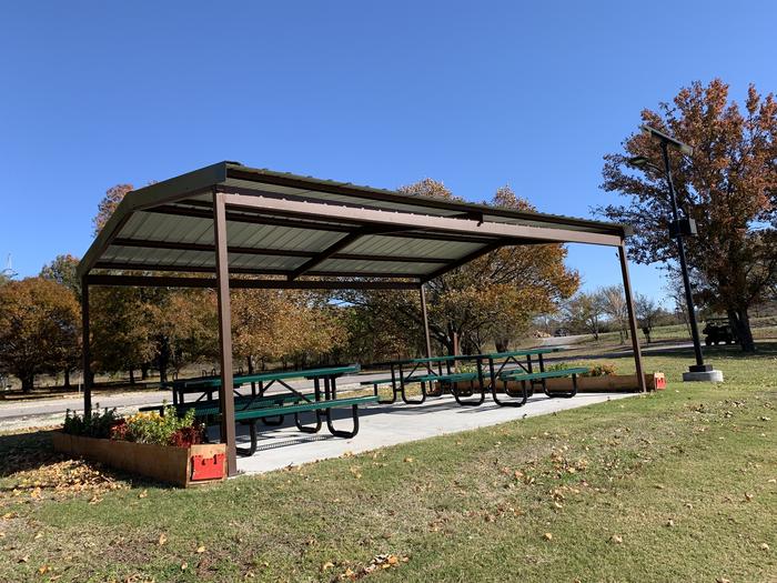 Guest and visitors have the availability to day use in a shelter at Brush Creek located near the campsites and below the fitness trail and basketball court. A photo of facility Brush Creek Public Use Area with Picnic Table, Fire Pit, Shade, Waterfront, Water Hookup, Lean To / Shelter