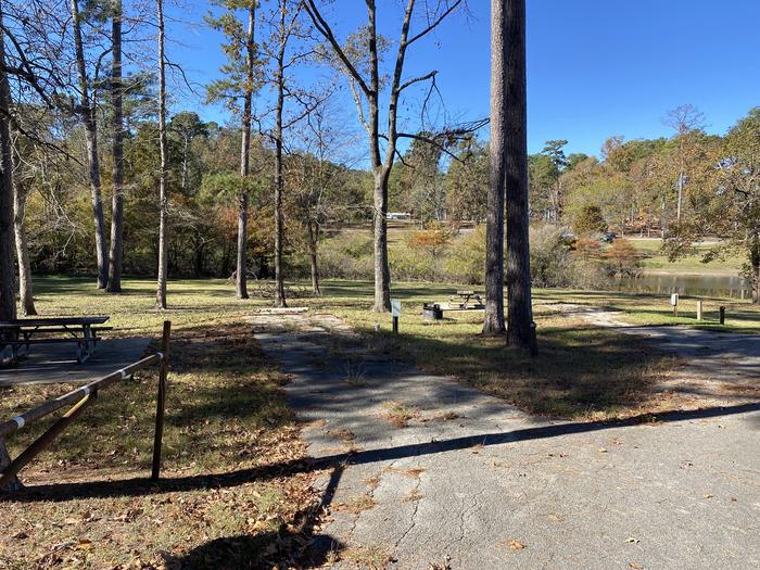 A photo of Site 28 of Loop LOOA at SAN AUGUSTINE with Picnic Table, Electricity Hookup, Fire Pit, Shade, Lantern Pole, Water Hookup