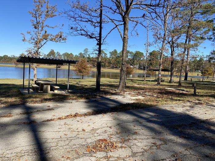 A photo of Site 14 of Loop LOOA at SAN AUGUSTINE with Picnic Table, Electricity Hookup, Fire Pit, Shade, Waterfront, Lantern Pole, Water Hookup, Lean To / Shelter
