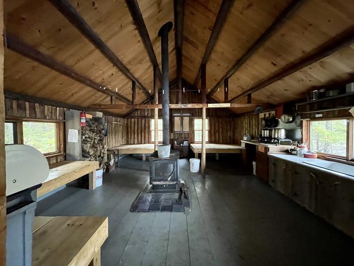 Platform bunks, wood stove and kitchen in Haskell HutThe spacious interior of Haskell Hut includes a woodstove, two double and four single platform bunks.
