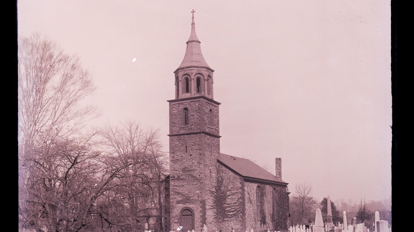 Masonry church, with steeple and a cross, and trees on one sideSt. Paul's Church, in the 1930s