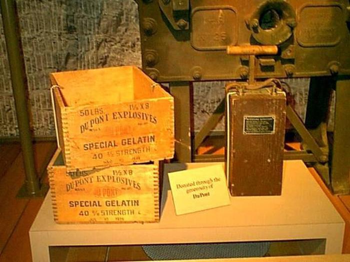 Dynamite Boxes and Blasting MachinePhoto of two wooden dynamite storage boxes and a blasting machine used to detonate explosive charges.