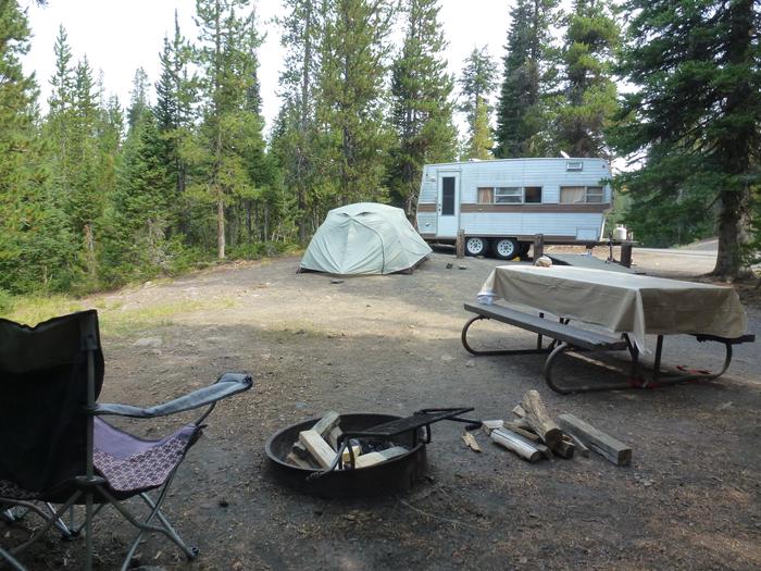 Lewis Lake site 24 picnic table, fire ring, camping equipment, and trailer. Lewis Lake site 24