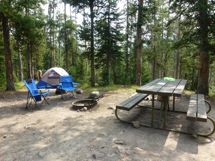 Lewis Lake site 53 fire ring, picnic table, and camping equipment.Lewis Lake site 53