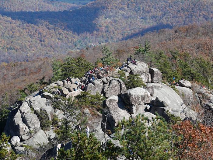 A group of hikers standing on a rock cliff at Old Rag Mountain.Old Rag offers views that make you feel like you're on top of the world. (Note: drones are not allowed in the Park!)