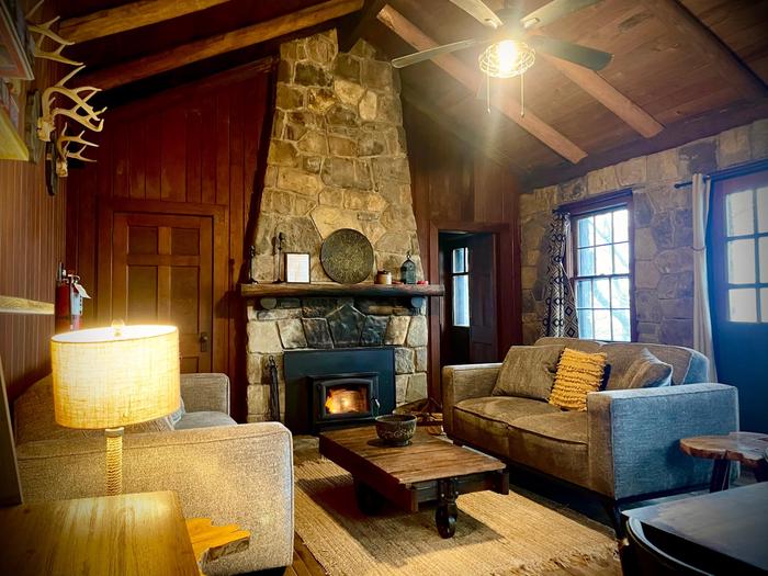 White Rock Mountain, Cabin C Living Room with two twin rollaway beds in closet. Fireplace.Check out these lovely rock walls!