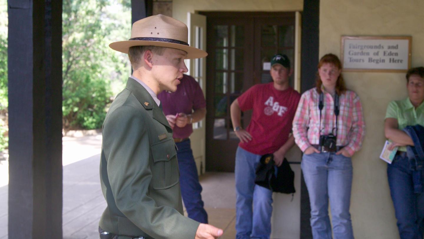 A ranger in the foreground talks to a group of visitors.All cave access is by guided tour.