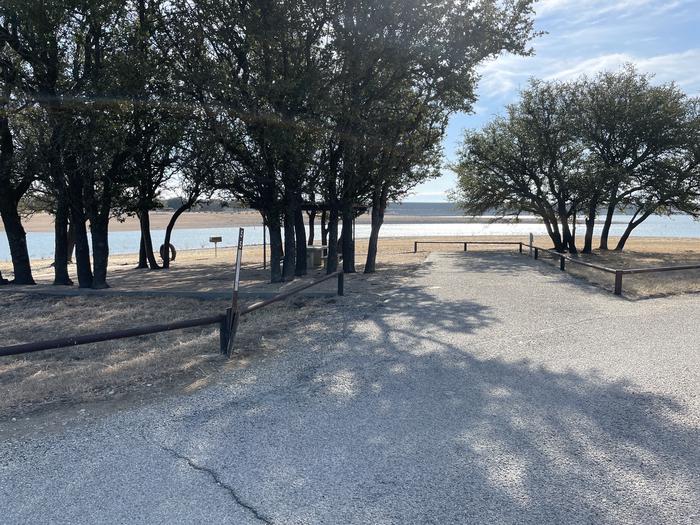 A photo of Site T055 of Loop L2 at LAKESIDE (TX) with Picnic Table, Fire Pit, Shade, Full Hookup, Waterfront