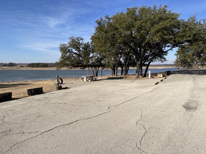 A photo of Site T012 of Loop L1 at LAKESIDE (TX) with Picnic Table, Electricity Hookup, Fire Pit, Waterfront, Water Hookup