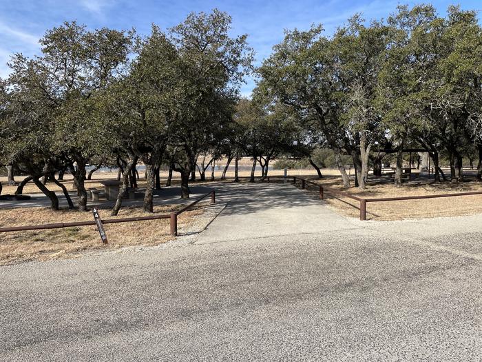 A photo of Site T044 of Loop L2 at LAKESIDE (TX) with Picnic Table, Fire Pit, Shade, Full Hookup