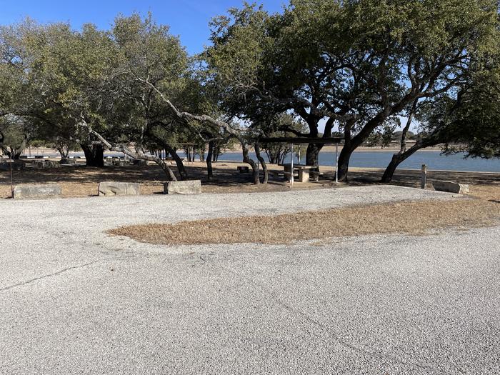 A photo of Site 411 of Loop 4 at FLATROCK (TEXAS) with Picnic Table, Electricity Hookup, Fire Pit, Shade, Water Hookup