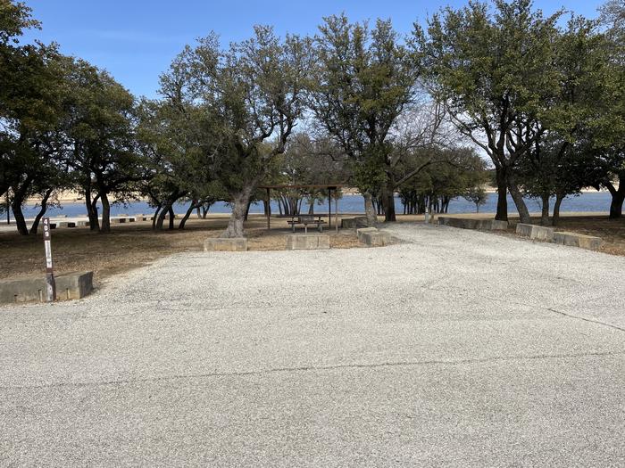 A photo of Site 409 of Loop 4 at FLATROCK (TEXAS) with Picnic Table, Electricity Hookup, Shade, Waterfront, Water Hookup