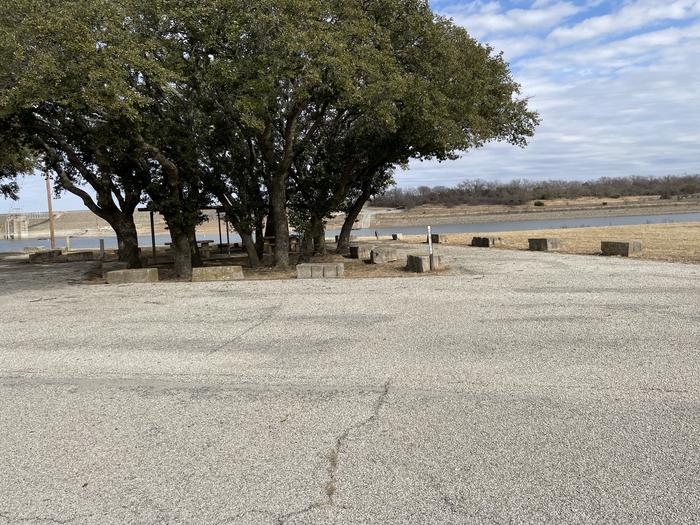 A photo of Site 111 of Loop 1 at FLATROCK (TEXAS) with Picnic Table, Electricity Hookup, Fire Pit, Shade, Waterfront, Water HookupA photo of Site 111 of Loop 1 at FLATROCK (TEXAS) with Picnic Table, Electricity Hookup, Fire Pit, Shade, Water Hookup, Double Site