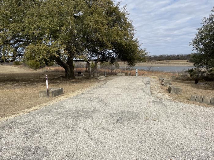 A photo of Site 103 of Loop 1 at FLATROCK (TEXAS) with Picnic Table, Electricity Hookup, Fire Pit, Shade, Water Hookup