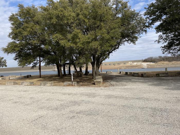 A photo of Site 112 of Loop 1 at FLATROCK (TEXAS) with Picnic Table, Electricity Hookup, Fire Pit, Shade, Waterfront, Water Hookup
