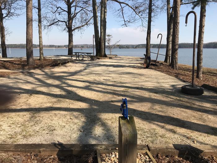 A photo of Site 56 of Loop LOOG at WHITETAIL RIDGE with Picnic Table, Electricity Hookup, Fire Pit, Shade, Tent Pad, Waterfront, Lantern Pole, Water Hookup