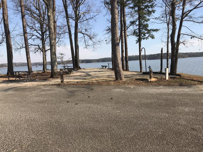 A photo of Site 56 of Loop LOOG at WHITETAIL RIDGE with Picnic Table, Electricity Hookup, Fire Pit, Shade, Tent Pad, Waterfront, Water Hookup