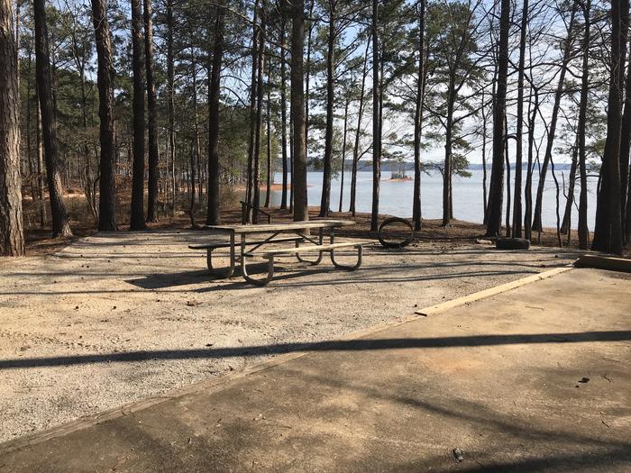 A photo of Site 10 of Loop LOOA at WHITETAIL RIDGE with Picnic Table, Electricity Hookup, Fire Pit, Shade, Tent Pad, Waterfront, Lantern Pole, Water Hookup
