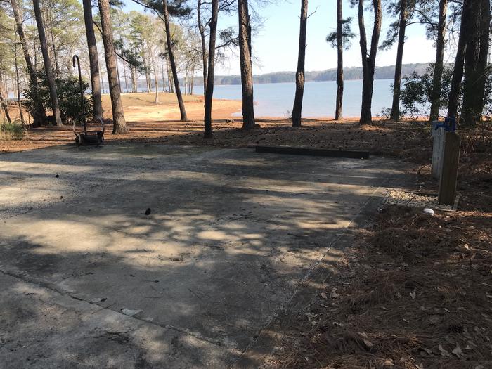 A photo of Site 48 of Loop LOOF at WHITETAIL RIDGE with Picnic Table, Electricity Hookup, Fire Pit, Shade, Tent Pad, Waterfront, Lantern Pole, Water Hookup