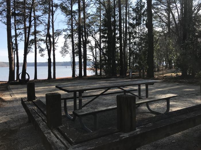 A photo of Site 48 of Loop LOOF at WHITETAIL RIDGE with Picnic Table, Electricity Hookup, Fire Pit, Shade, Tent Pad, Waterfront, Lantern Pole, Water Hookup