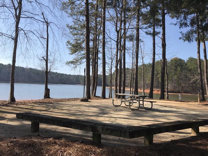 A photo of Site 15 of Loop LOOB at WHITETAIL RIDGE with Picnic Table, Electricity Hookup, Fire Pit, Shade, Tent Pad, Waterfront, Lantern Pole, Water Hookup