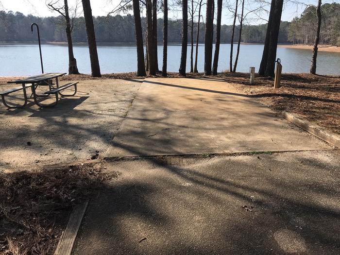 A photo of Site 15 of Loop LOOB at WHITETAIL RIDGE with Picnic Table, Electricity Hookup, Fire Pit, Shade, Tent Pad, Waterfront, Lantern Pole, Water Hookup