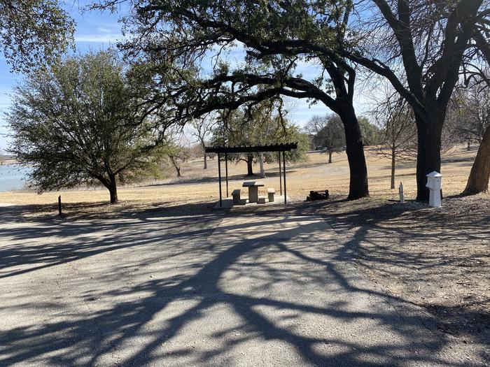 A photo of Site 043 of Loop SOUT at Holiday (Texas) with Picnic Table, Electricity Hookup, Fire Pit, Shade, Water Hookup