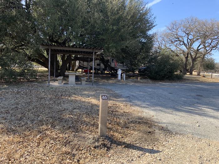 A photo of Site 046 of Loop SOUT at Holiday (Texas) with Picnic Table, Electricity Hookup, Fire Pit, Water Hookup
