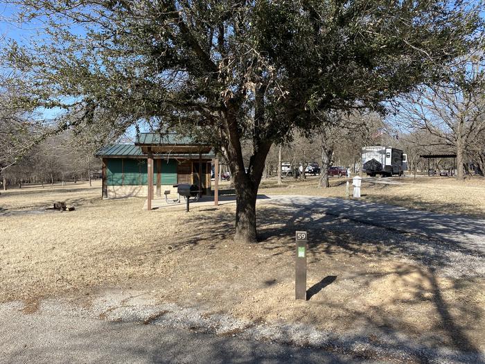 A photo of Site 059 of Loop SOUT at Holiday (Texas) with Picnic Table, Electricity Hookup, Shade, Water Hookup, Lean To / Shelter
