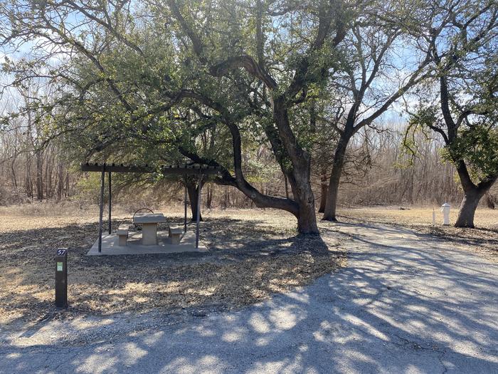 A photo of Site 057 of Loop SOUT at Holiday (Texas) with Picnic Table, Electricity Hookup, Fire Pit, Shade, Water Hookup