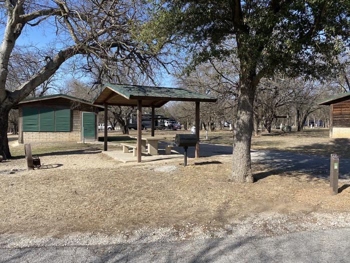 A photo of Site 060 of Loop SOUT at Holiday (Texas) with Picnic Table, Electricity Hookup, Fire Pit, Shade, Water Hookup, Lean To / Shelter