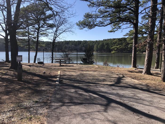 A photo of Site 054 of Loop NORTH SHORE at CEDAR LAKE (OKLAHOMA) with Boat Ramp, Picnic Table, Fire Pit, Tent Pad, Waterfront, Lantern Pole