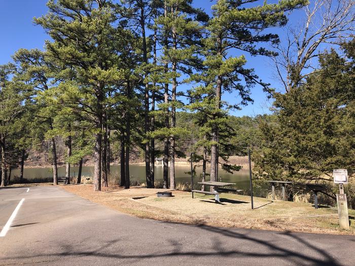 A photo of Site 051 of Loop NORTH SHORE at CEDAR LAKE (OKLAHOMA) with Boat Ramp, Picnic Table, Fire Pit, Tent Pad, Waterfront, Lantern Pole