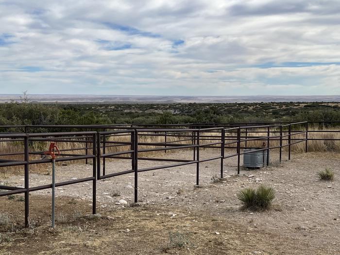 The horse corrals are separated into 4 areas by metal fencing.  Two corrals share one water trough with a spigot the remaining 2 corrals have a spigot available.A view of the horse corrals with the Permian Basin views to the southeast of the area.