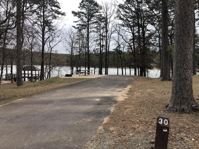 A photo of Site 030 of Loop SANDY BEACH at CEDAR LAKE (OKLAHOMA) with Picnic Table, Electricity Hookup, Fire Pit, Tent Pad, Waterfront, Lantern Pole, Water Hookup
