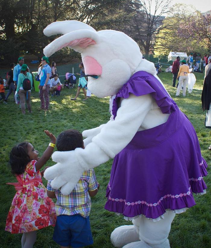 An Easter bunny mascot with children.Guests attend the White House Easter Egg Roll, on the South Lawn of the White House. 