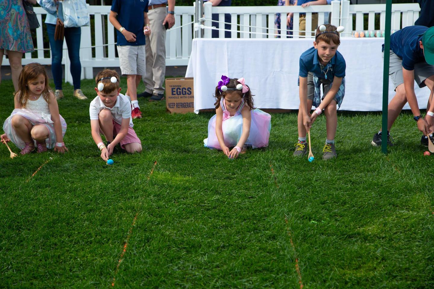 A close-up of children participating in the egg roll