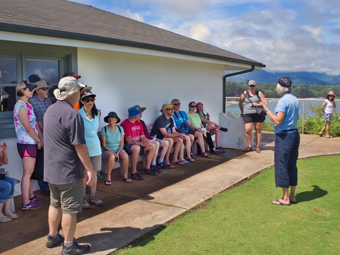 Visitors gathered for a tourVolunteer addressing a tour group
