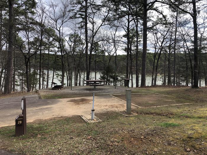 A photo of Site 028 of Loop SANDY BEACH at CEDAR LAKE (OKLAHOMA) with Picnic Table, Electricity Hookup, Fire Pit, Tent Pad, Lantern Pole, Water Hookup