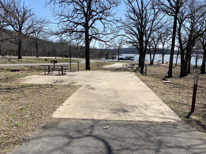A photo of Site 16 of Loop PBA2 at PETTIT BAY with Picnic Table, Electricity Hookup, Fire Pit, Shade, Water Hookup