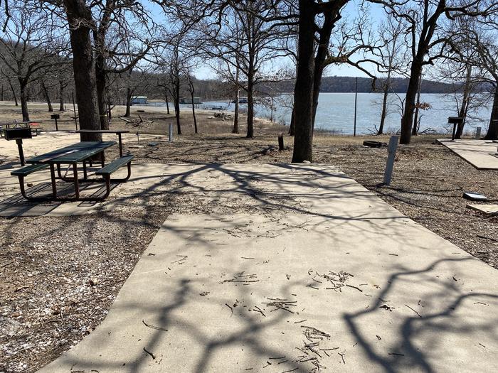 A photo of Site 19 of Loop PBA2 at PETTIT BAY with Picnic Table, Electricity Hookup, Fire Pit, Shade, Water Hookup