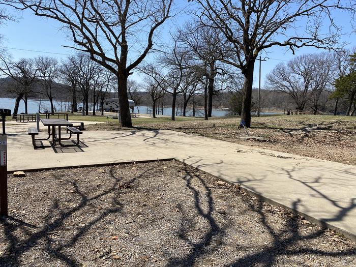 A photo of Site 26 of Loop PBA2 at PETTIT BAY with Picnic Table, Electricity Hookup, Fire Pit, Shade, Water Hookup