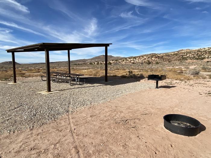 Campsite shade structure, grill, and fire pit with hills in the background.North Klondike Group Site B shade structure, grill, and fire pit.